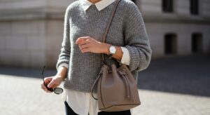 グレージュ色のミニマルなバッグを持っている女性